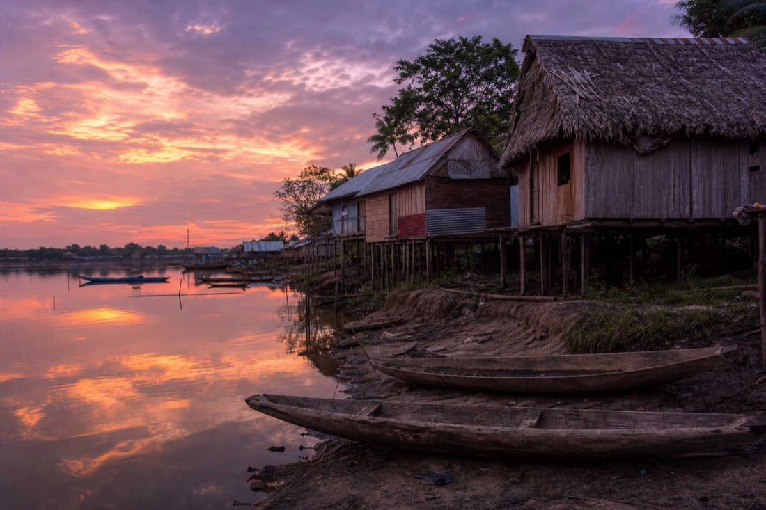Stilt houses of a small village along the calm Yarinacocha lakeshore near Pucallpa at dusk