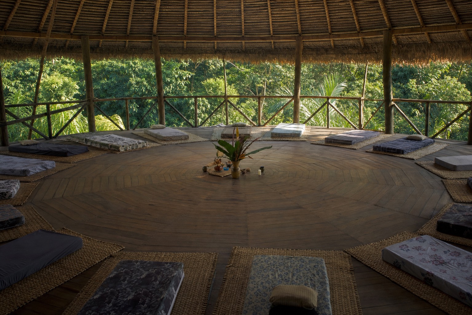 Simple thatched maloca ceremony space in the Peruvian Amazon, the setting an all-inclusive ayahuasca retreat price pays for
