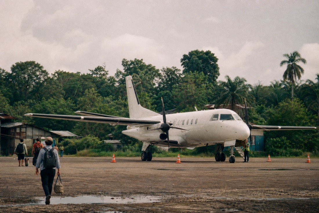 Small plane on the tarmac of a jungle airport in Peru, the flight to Iquitos being a hidden cost of an ayahuasca retreat