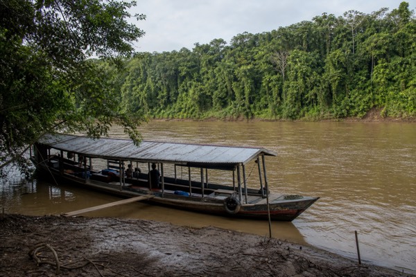 Riverboat on a wide Amazon tributary near Iquitos, the transfer route to jungle ayahuasca retreat centers